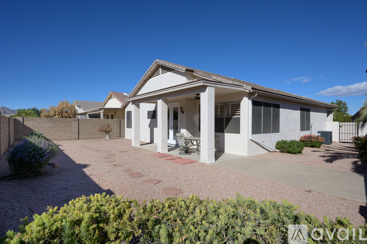 A house with a white exterior and a covered patio area.