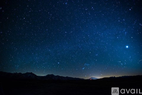 A starry night sky over a mountain range.