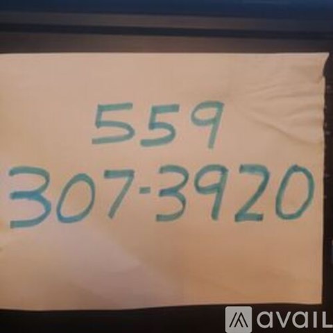 A white sign with the numbers 559 and 307-3920 written in blue.