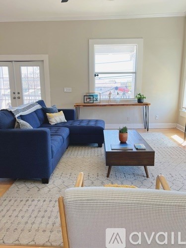 A living room with a blue couch and a coffee table.