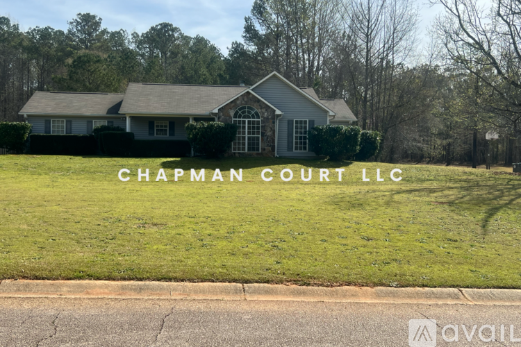 A house with the text "Chapman Court LLC" in front of it.