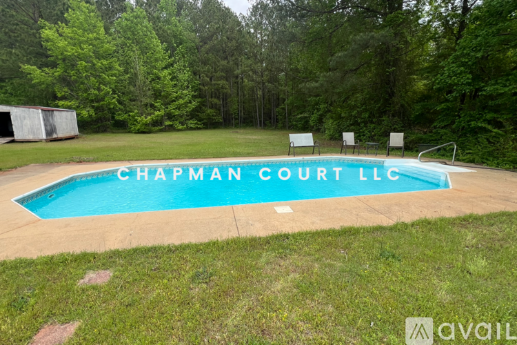 A pool with the words Chapman Court LLC written on it.