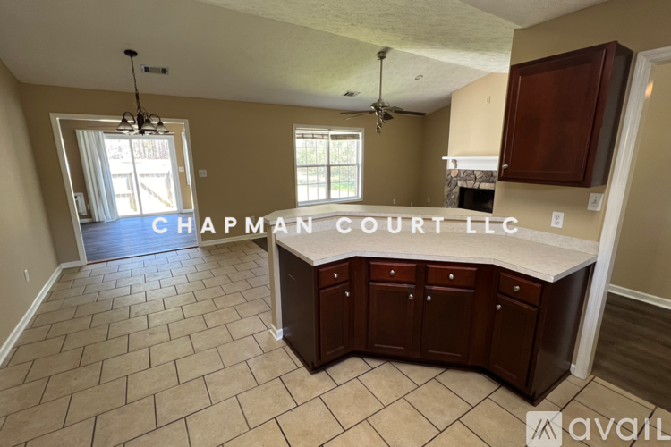 A kitchen with a tile floor and a sign that says "Chapman Court LLC".