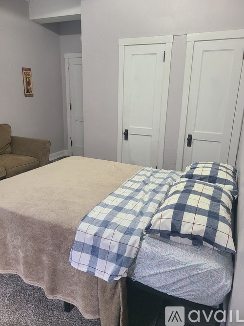 A bedroom with a bed and a couch.