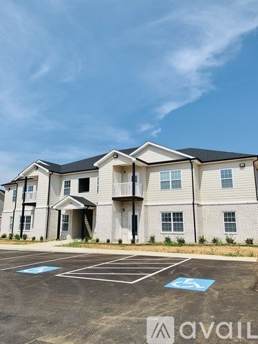 A large two-story building with a parking lot in front.