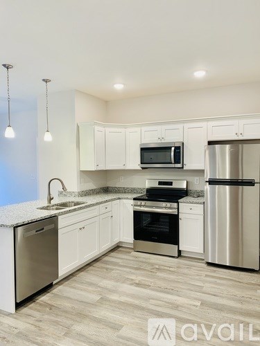 A kitchen with white cabinets and stainless steel appliances.
