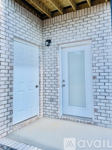 A white door is on the left and a white door with a glass panel is on the right.
