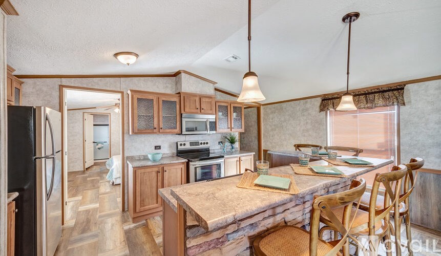 A kitchen with wooden cabinets and a stone countertop.