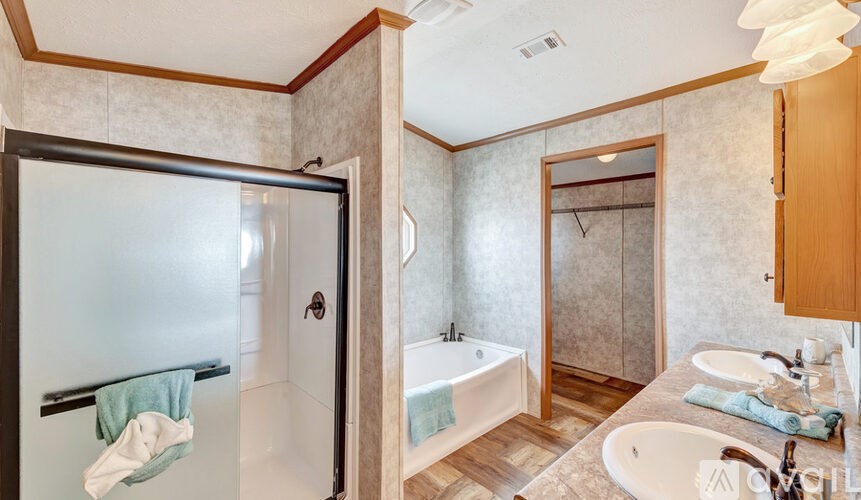 A bathroom with a white tub and sink.