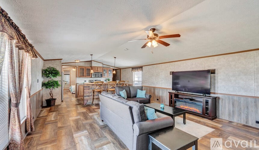 A living room with a grey couch and a television.