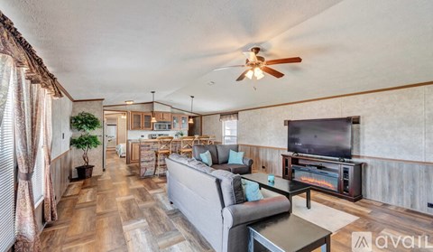 A living room with a grey couch and a television.