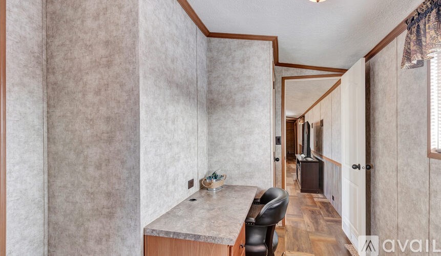 A bathroom with a marble countertop and a chair.