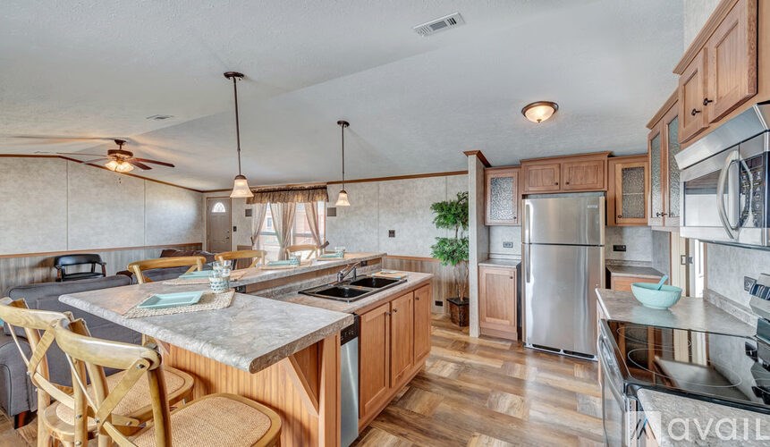 A kitchen with wooden cabinets and a marble countertop.