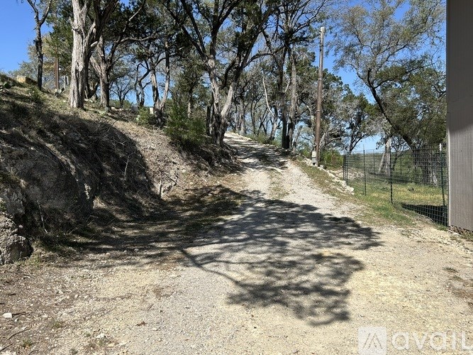 A dirt path winds through a wooded area.