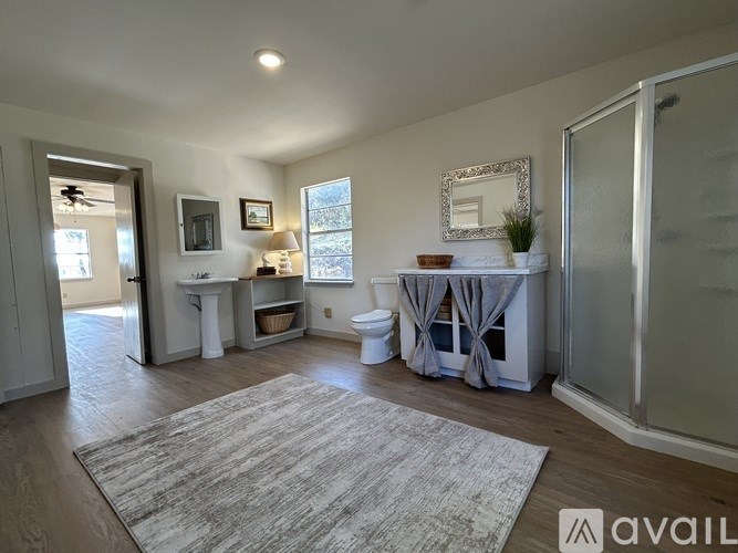 A bathroom with a toilet, sink, and bathtub.