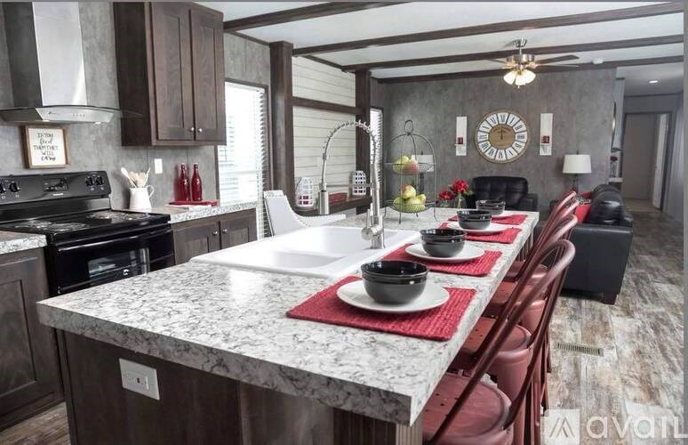 A kitchen with a marble countertop and a dining table set for two.