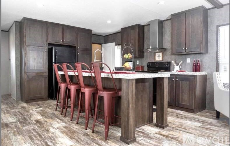A kitchen with dark wood cabinets and a white countertop.