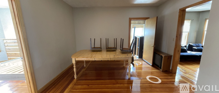 A room with a long table and chairs in the middle.