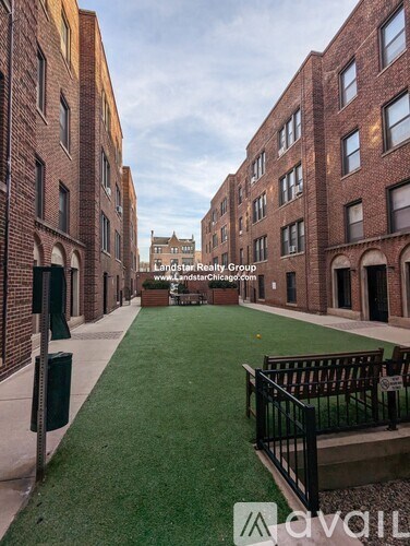 A long, narrow courtyard between two brick buildings.