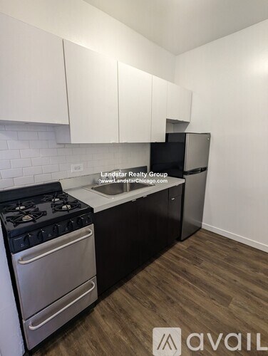 A kitchen with a stove and a refrigerator.