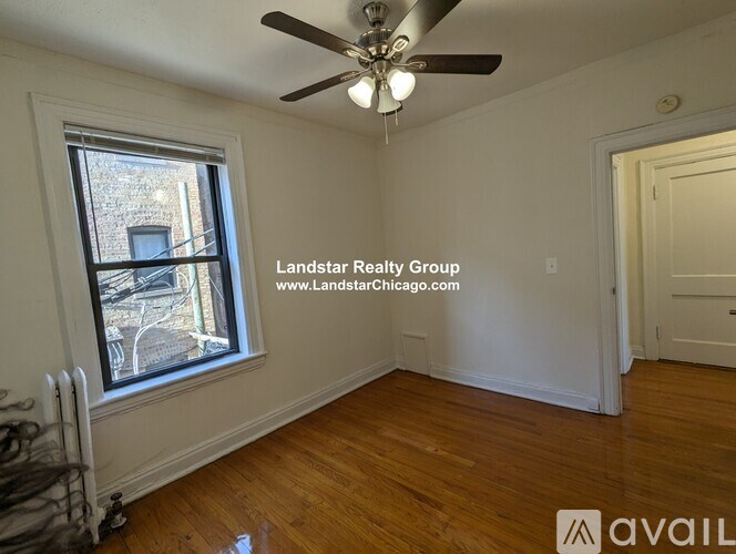 A room with a window and a ceiling fan.