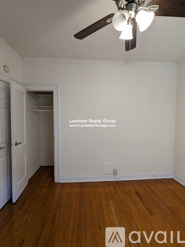 A room with a wooden floor and a ceiling fan.