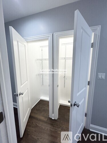 A hallway with three doors and a window.