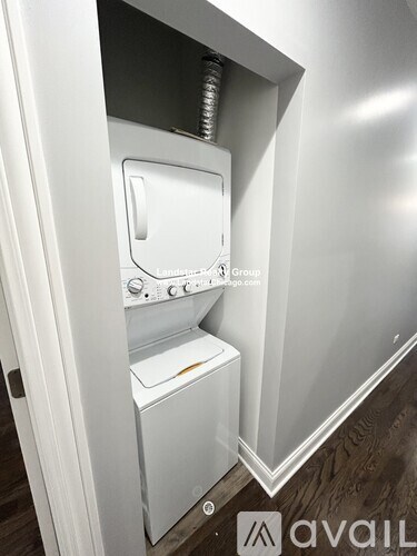 A white washing machine is built into a wall.