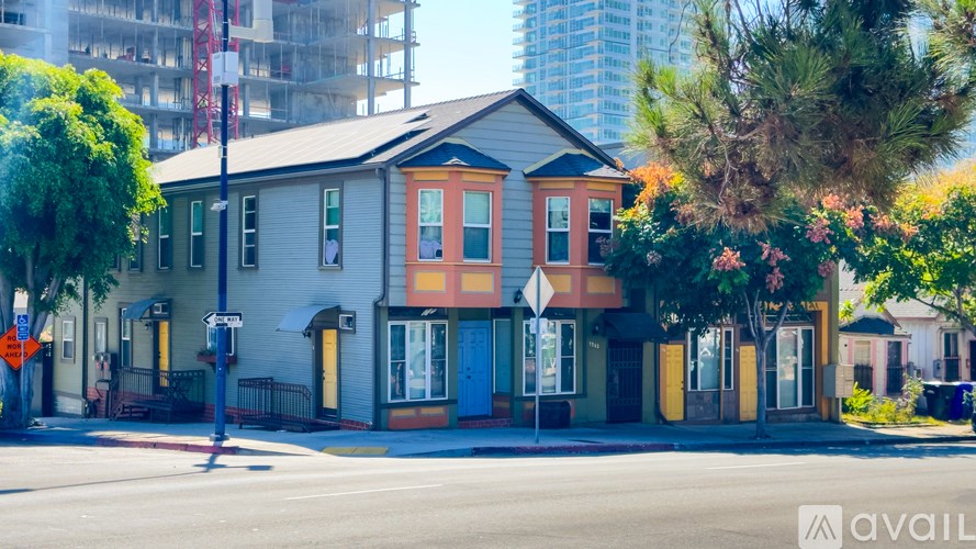 A row of houses with different colored front doors.