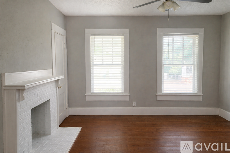 A kitchen with a sink, cabinets, and a refrigerator.
