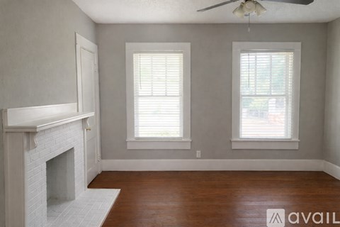 A kitchen with a sink, cabinets, and a refrigerator.