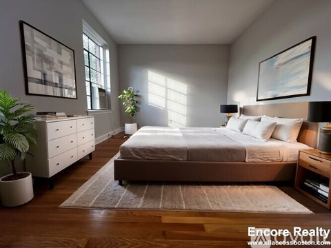 A well-lit bedroom with a large bed, a dresser, and a potted plant.
