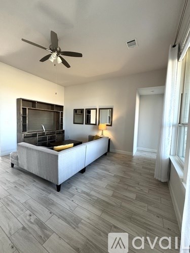 A living room with a television and a couch.