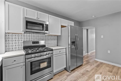 A kitchen with a stove, oven, refrigerator, and microwave.