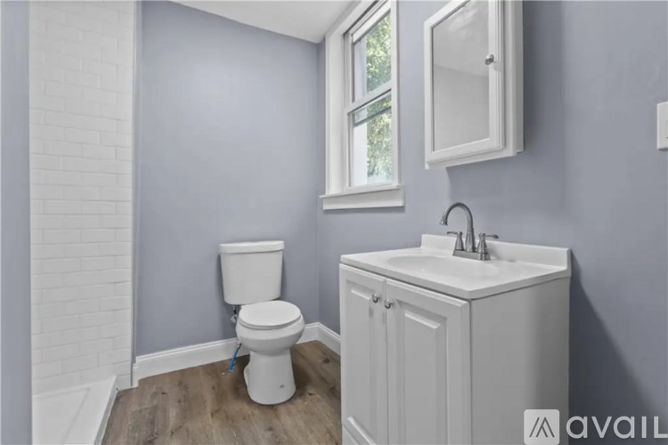 A white toilet and sink in a bathroom.