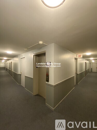 A long hallway with Landstar Realty Group signage.