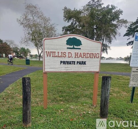 A park with a paved path and trees.