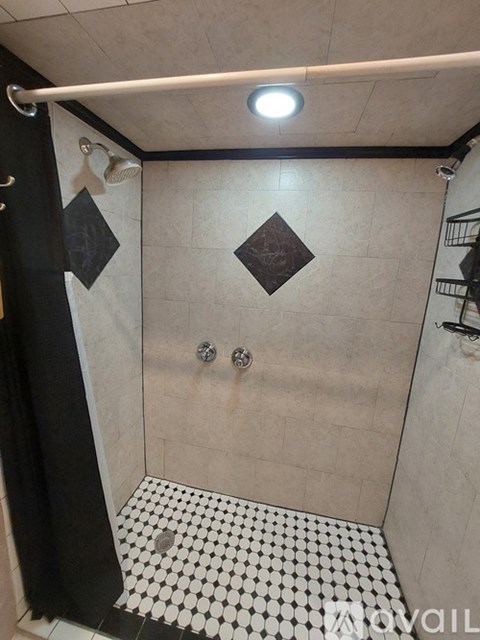 A white toilet in a bathroom with a cabinet above it.