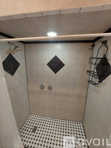 A bathroom with a sink, mirror, and shower curtain.