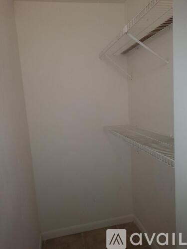 A white wall with a shelf and a logo that says "avaiL".