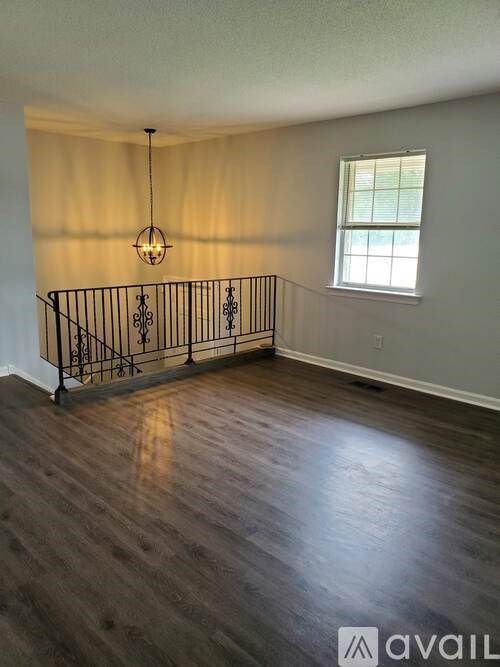 A room with wooden floors and a window.