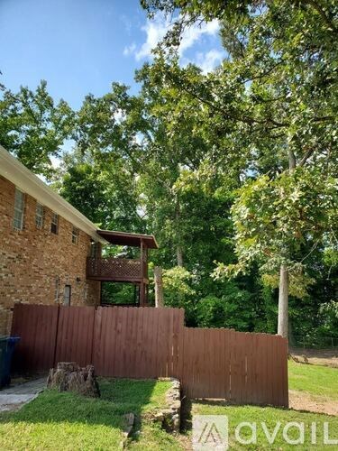 A house with a wooden fence in front of it.