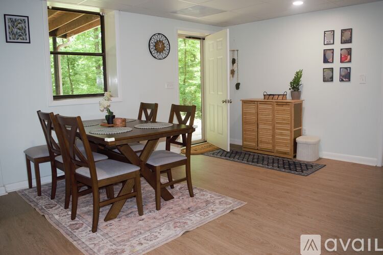 A dining room with a table set for four.