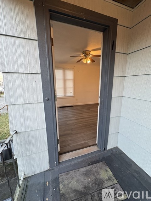 A doorway with a fan in the room.