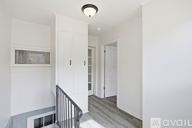 A hallway with a staircase leading to the second floor.