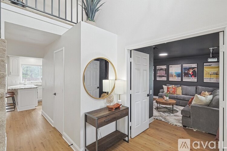 A well-lit living room with a grey sofa and a wooden coffee table.