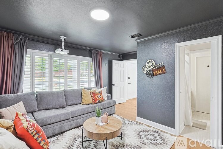 A living room with a grey couch and a coffee table.