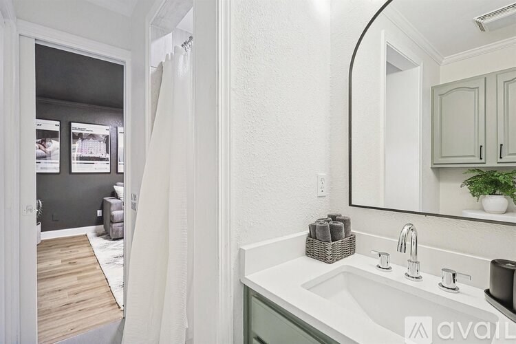 A bathroom with a white sink and a mirror.