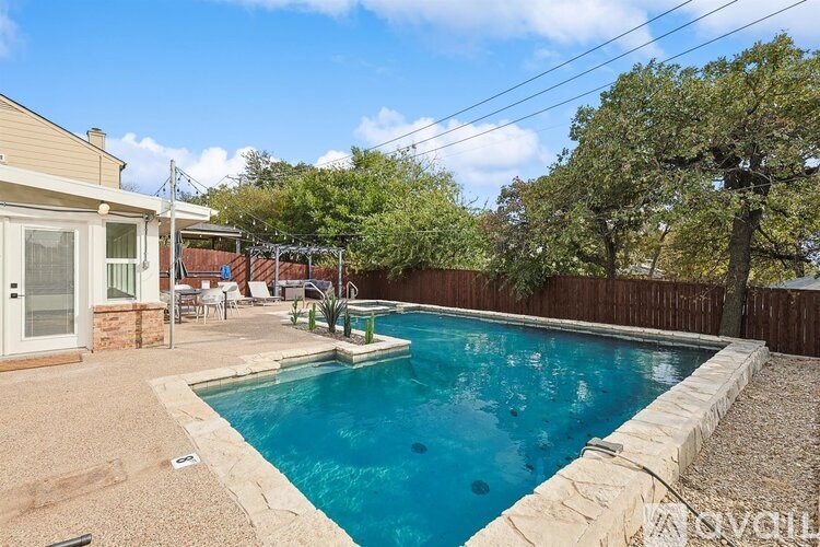 A residential backyard with a small pool and patio area.