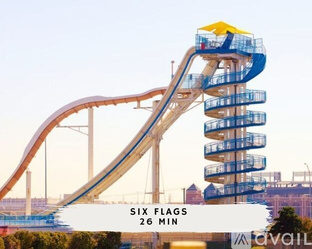 A large amusement park ride called Six Flags with a blue and yellow slide.